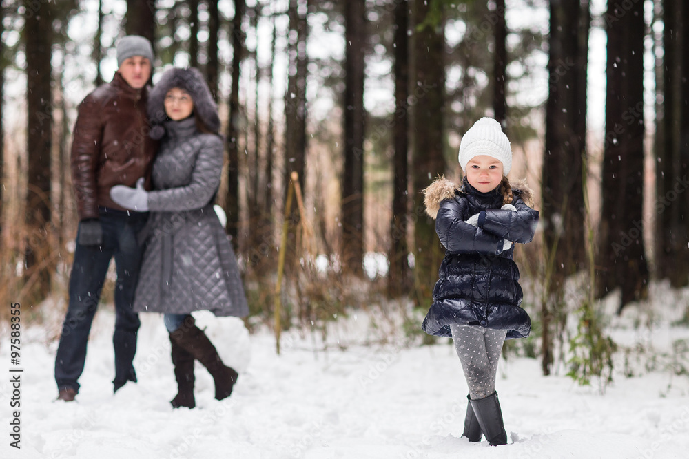 Happy family walking in a winter park.
