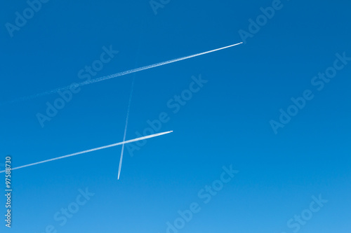 Jet Trails Pattern On Blue Sky