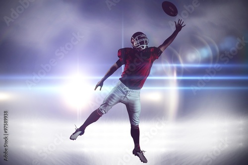 American football player trying to catch football ball © vectorfusionart