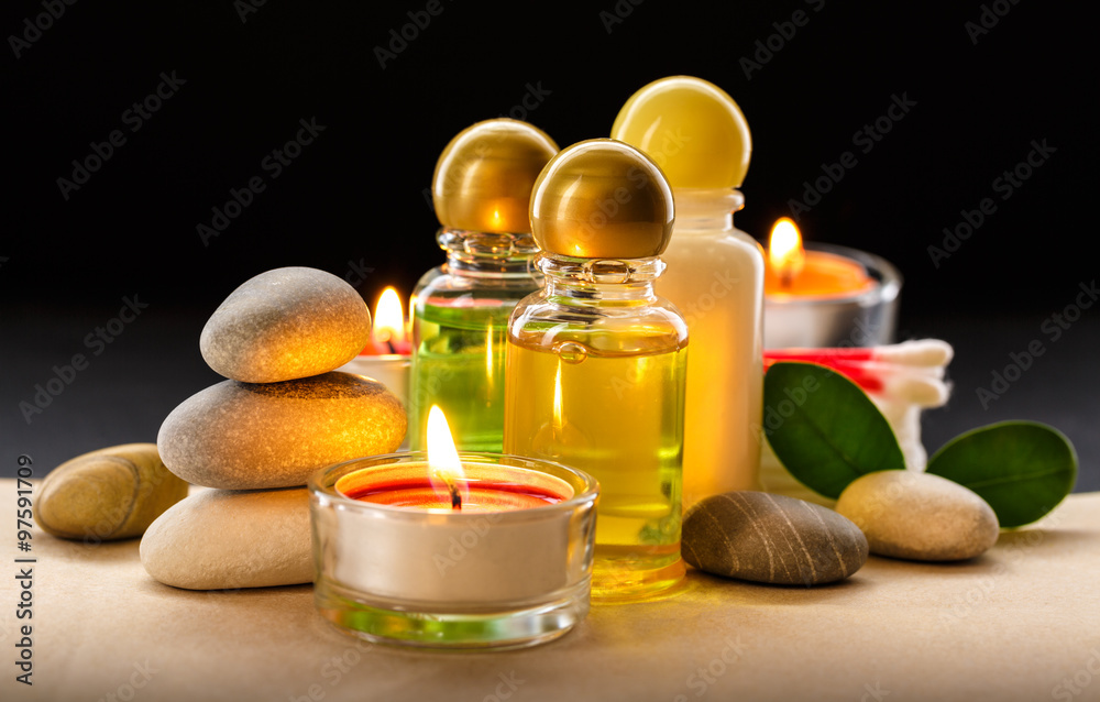 Spa stones, candle and shampoo bottles