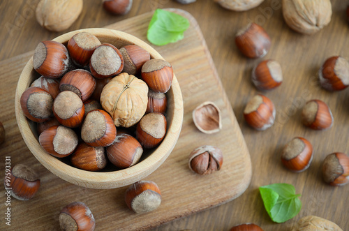 Hazelnuts and walnuts in a wooden bowl 