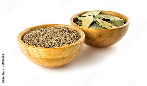 Indian cumin seeds and bay leaves isolated on white