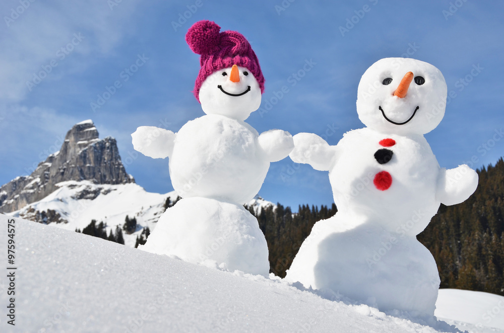 Obraz premium Funny snowmen against Swiss Alps