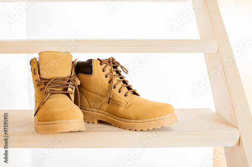 yellow leather shoes on wooden ladder