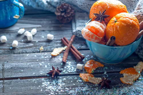 Tangerine in scarf over wooden background