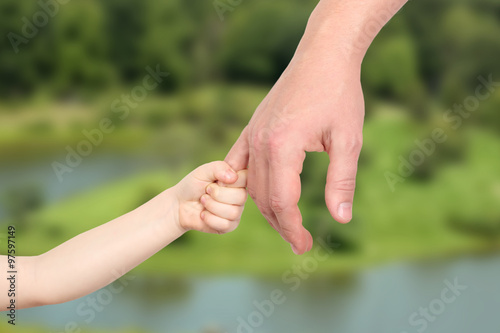 Child holds father`s hand © Saklakova