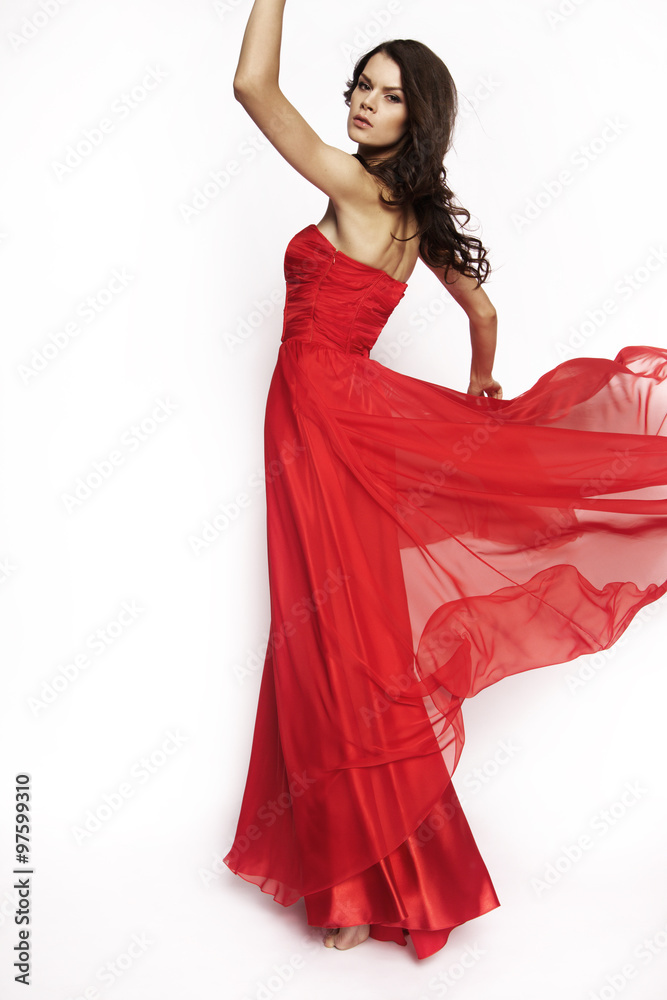 Brunette model in red dress posing
Brunette model in red dress posing
