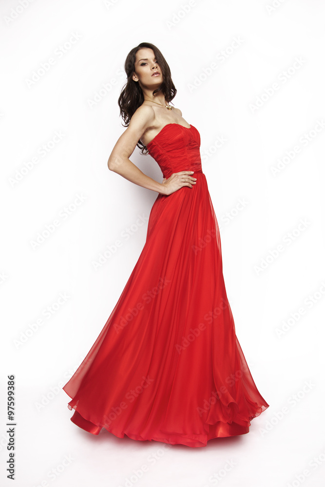 Brunette model in red dress posing
