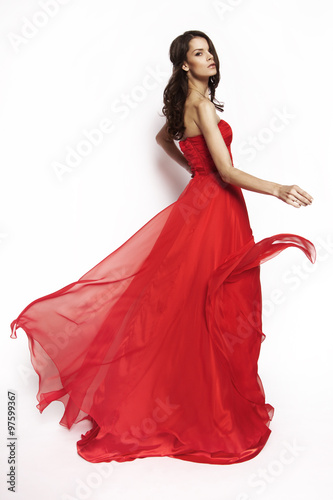 Brunette model in red dress posing
