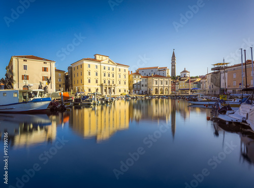 Venetian Port and The Main Square Tartini of Piran City Reflected on Water in Slovenia.