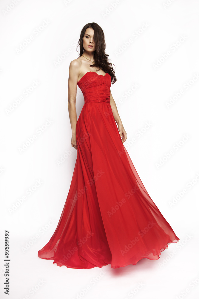 Brunette model in red dress posing
