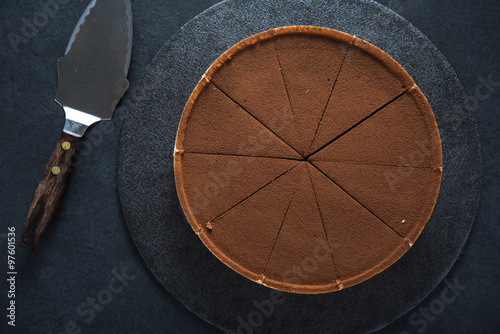 Sliced chocolate tort on dark background