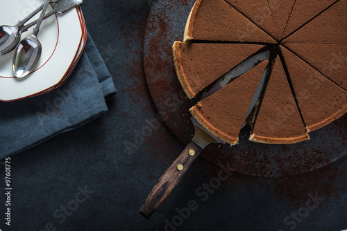Sliced chocolate tort on dark background