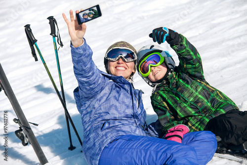 Mother and son take a selfie photo on ski resort