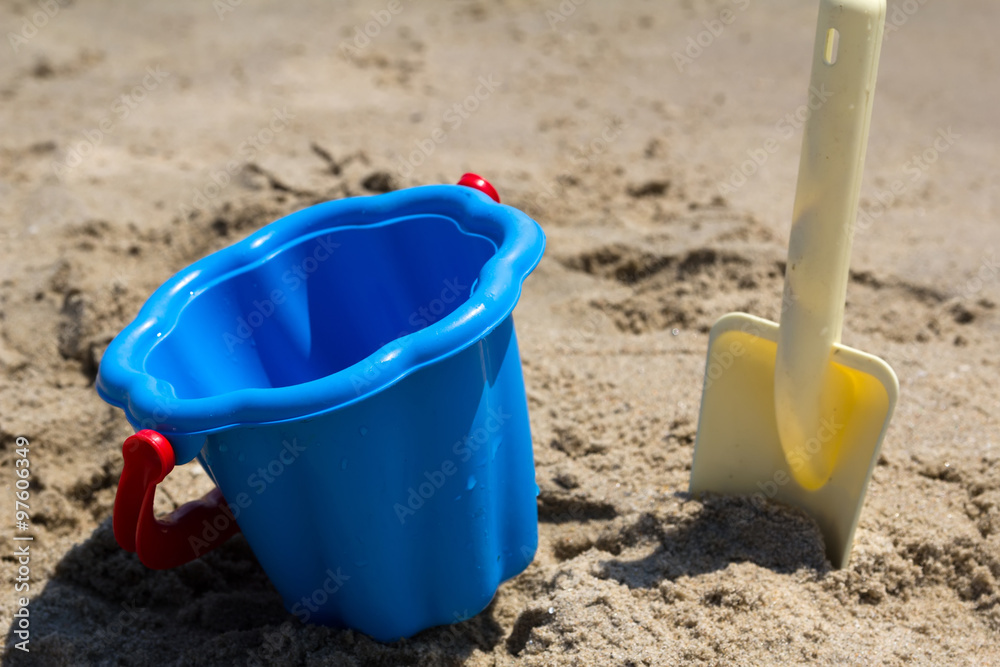Children's beach toys - buckets and shovel on sand. Sunny day Children's beach toys - buckets and shovel on sand. Sunny day