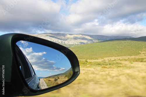 Side mirror view of the scenery during a trip in Croatia.