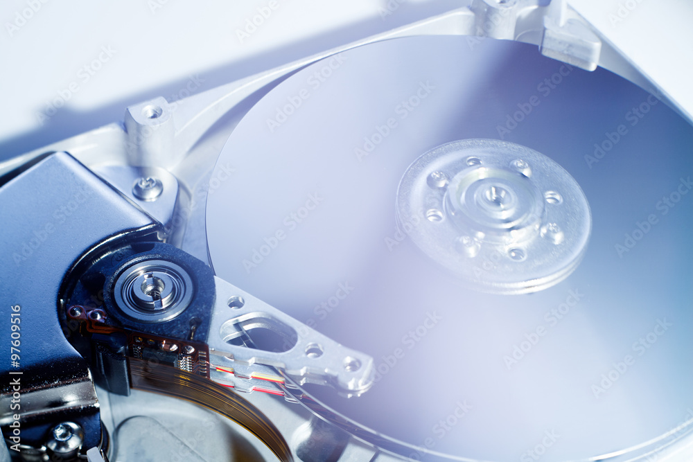 Opened Hard Disk Drive photographed with soft focus and soft flare with blue darktones