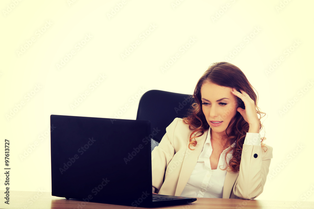 Focused businesswoman working on laptop. Focused businesswoman working on laptop.