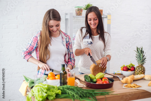 Gorgeous young Women preparing dinner in a kitchen concept cooking, culinary, healthy lifestyle