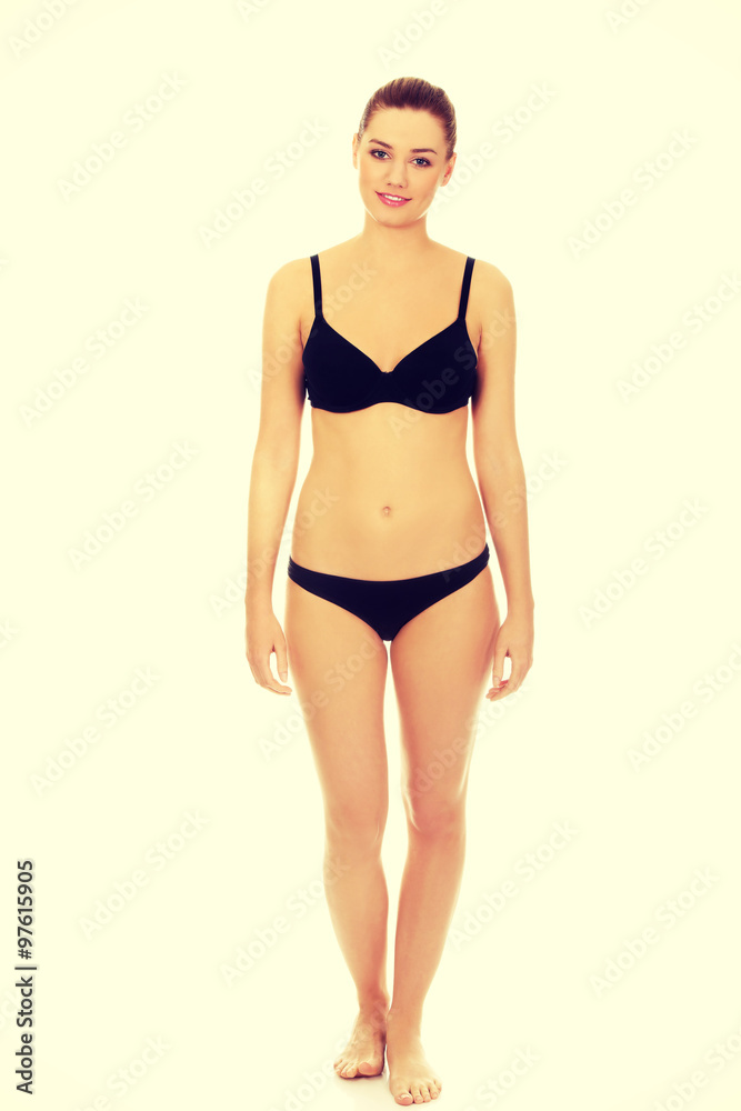 Fototapeta premium Happy woman standing in bikini.