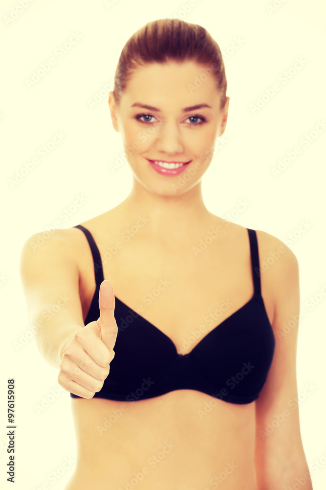 Obraz premium Woman in bikini with thumbs up.