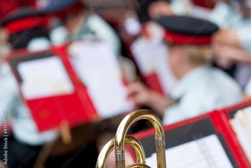 Obraz premium Close-up of Trombone with military band in the background