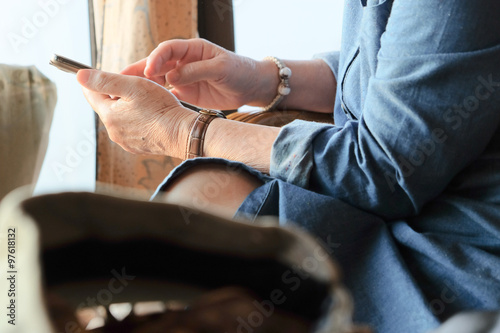 image of older woman checking her phone background 