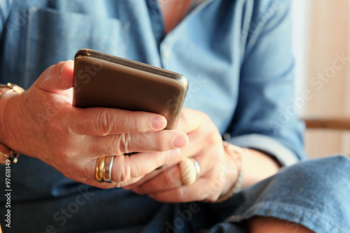 image of older woman checking her phone background 