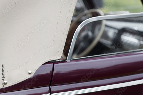 Window of purple convertible shiny classic vintage car