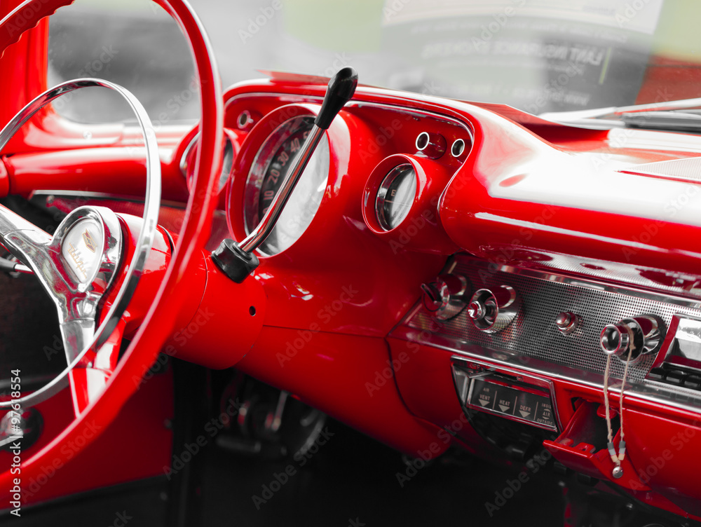 Close-up of red steering wheel of shiny classic vintage car