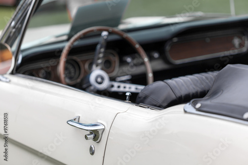 Close-up of car handle of a white shiny convertible vintage car