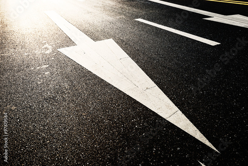 asphalt road with traffic sign under light