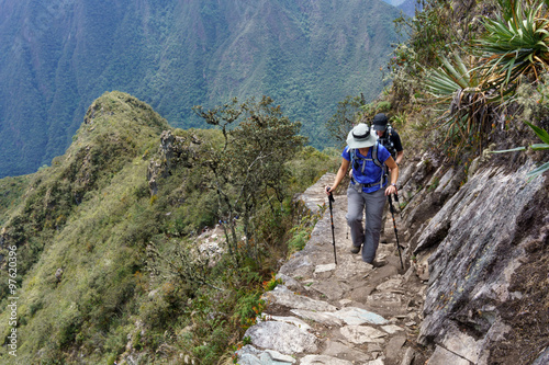 Two hikers walking on Inca trail of Machu Picchu, Cusco Region, Urubamba Province, Machupicchu District, Peru