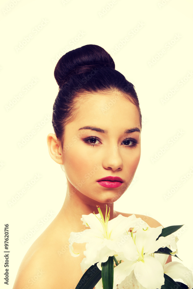 Fototapeta premium Beauty face of a woman with flower.