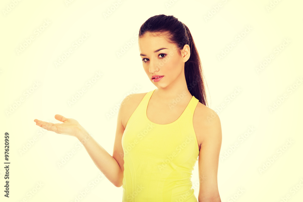 Beautiful woman in sportswear with empty hand. Beautiful woman in sportswear with empty hand.