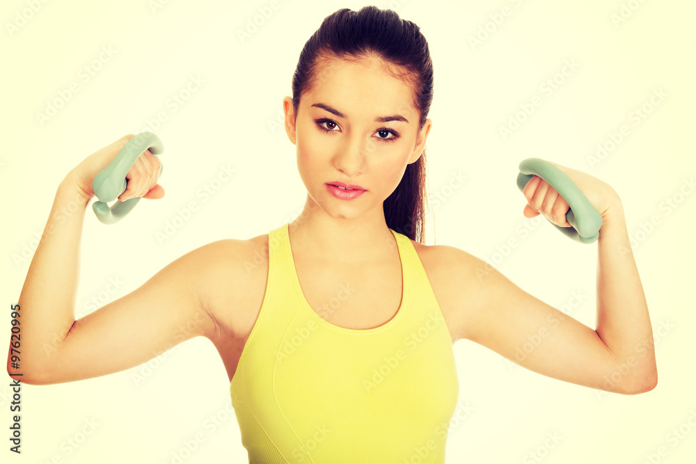 Active woman holding weights. Active woman holding weights.