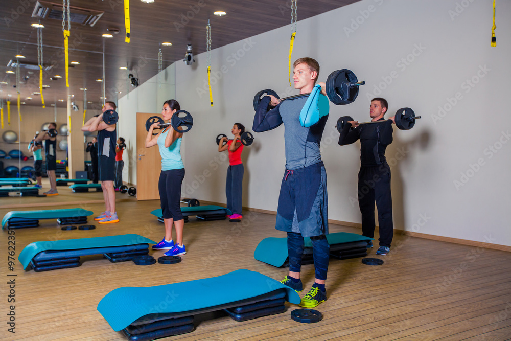 Obraz premium Sport, fitness, lifestyle and people concept - group flexing muscles with barbells in gym