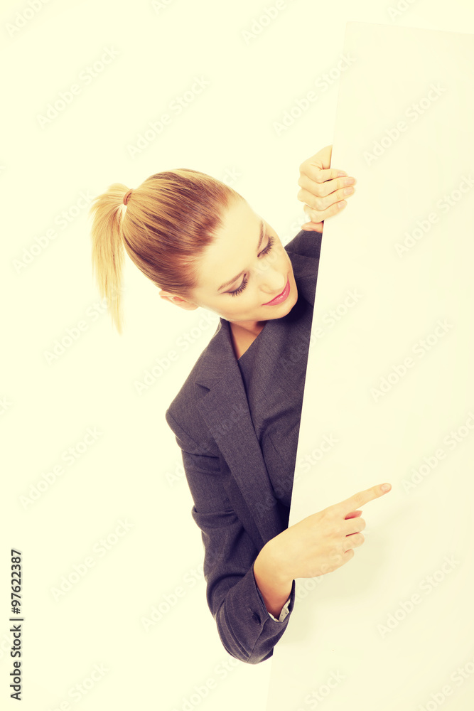 Businesswoman pointing on empty banner. Businesswoman pointing on empty banner.