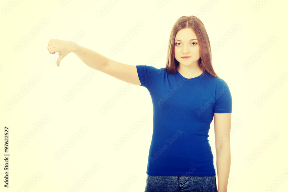 Young woman with thumbs down. Young woman with thumbs down.