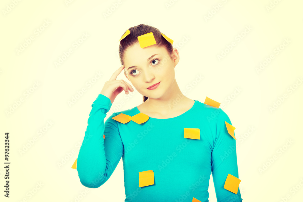 Young woman covered with post it notes. Young woman covered with post it notes.