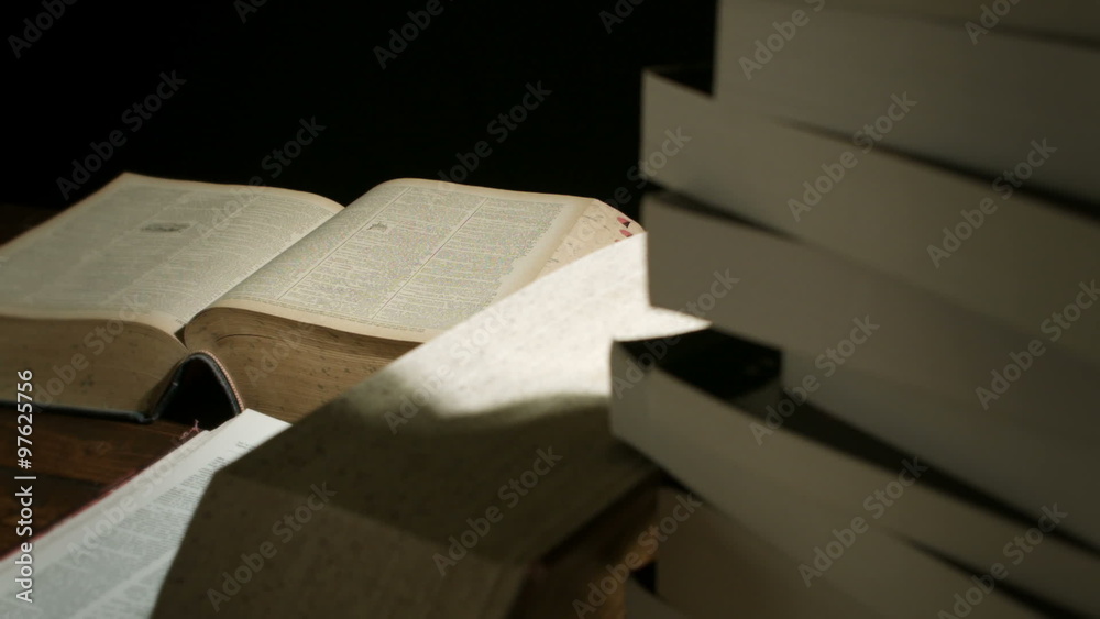 Dolly Motion Studio Shot of Big Books Stacked on a Desk at Night for any Education Concepts Dolly Motion Studio Shot of Big Books Stacked on a Desk at Night for any Education Concepts
