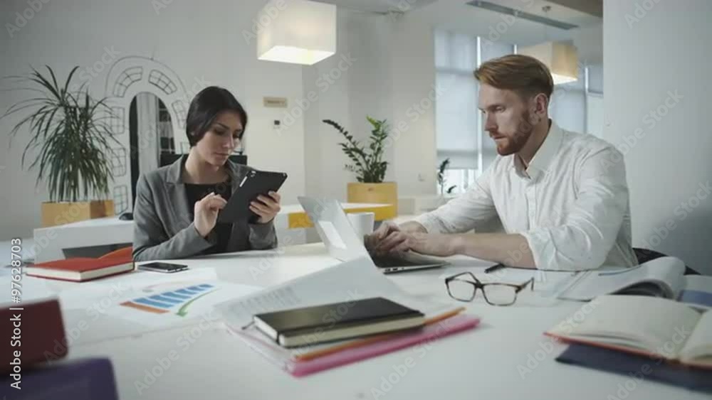 Twoemployees working in the office Twoemployees working in the office
