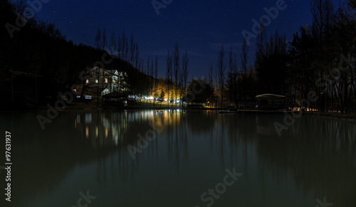 Reflected house in a lake at night in the mountains