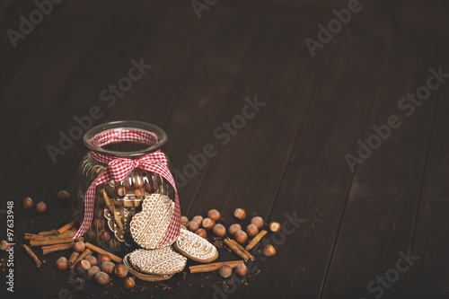 Gingerbread cookies in a jar on a wooden background