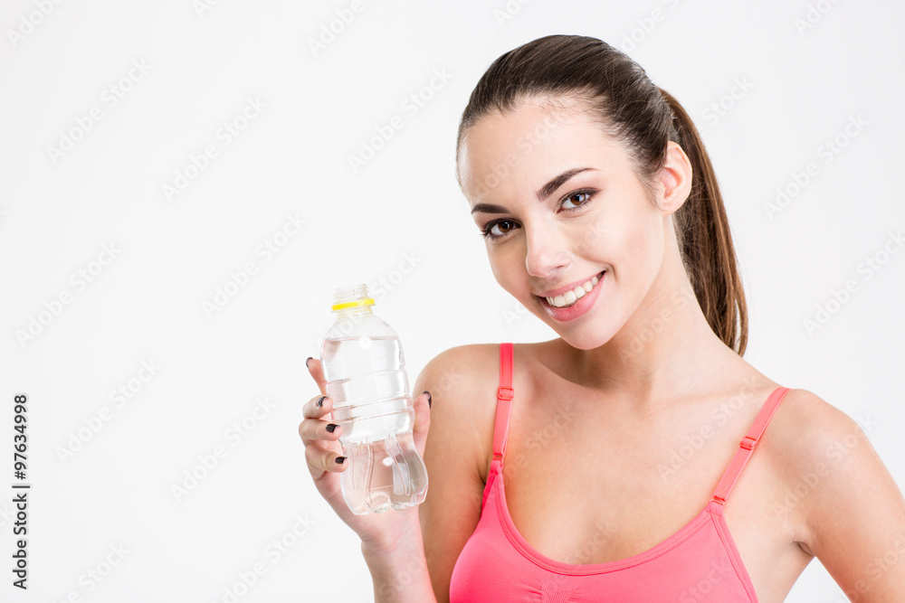 Cute lovely fitness girl holding a bottle of water Cute lovely fitness girl holding a bottle of water