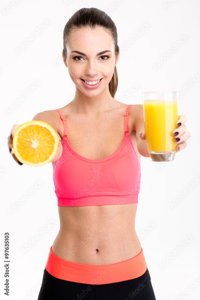 Beautiful fitness woman giving a juice and half of orange Beautiful fitness woman giving a juice and half of orange