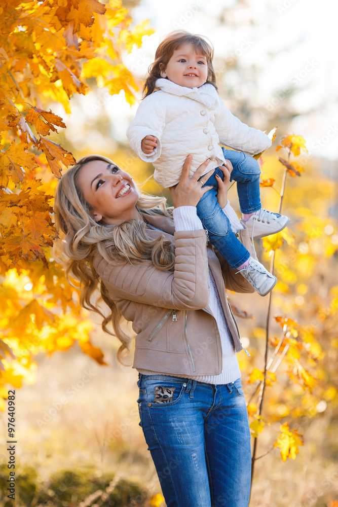 Mom and daughter resting in a park in autumn Mom and daughter resting in a park in autumn
