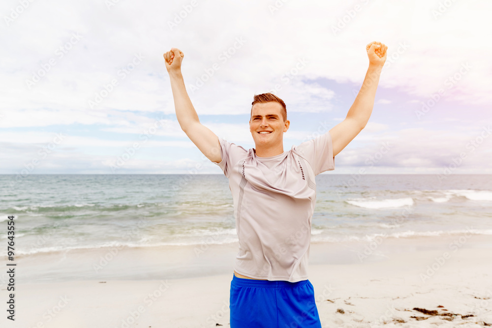 Young man in sport wear with outstretched arms Young man in sport wear with outstretched arms