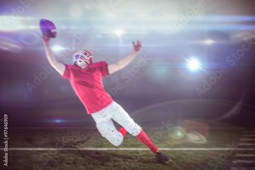 Composite image of american football player scoring a touchdown © vectorfusionart