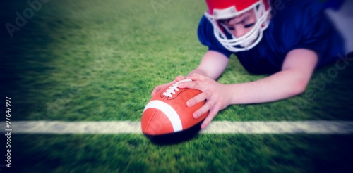 Tableau sur toile Composite image of american football player scoring a touchdown